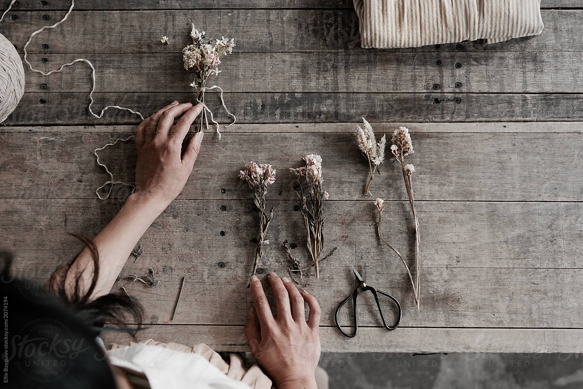 Young business owner making dried bouquets