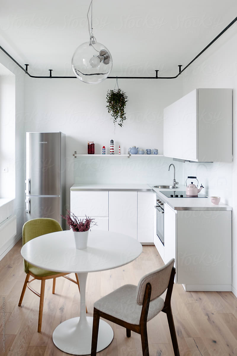 White table with two chairs in the kitchen of a small modern flat