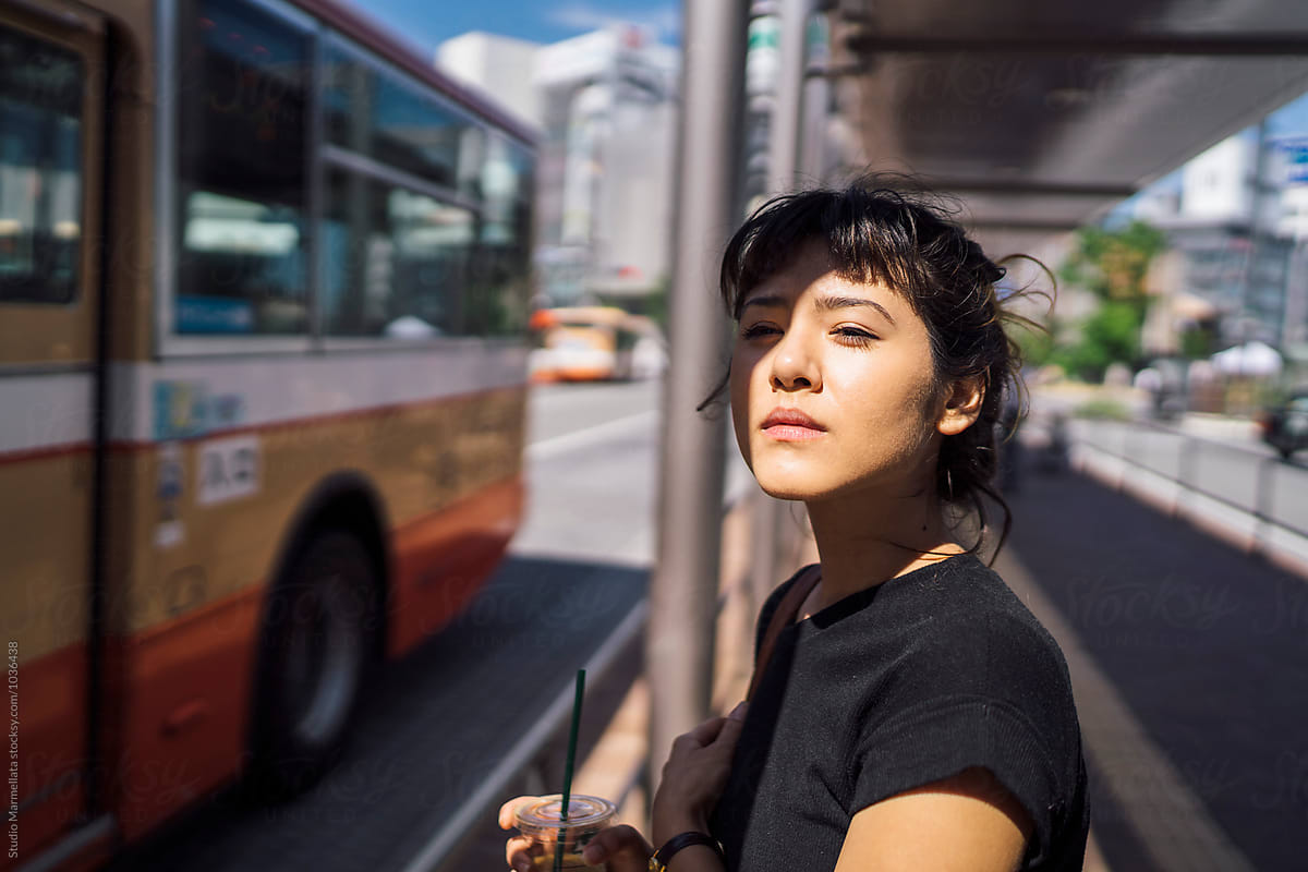 Japanese young woman at a bus stop in Japan