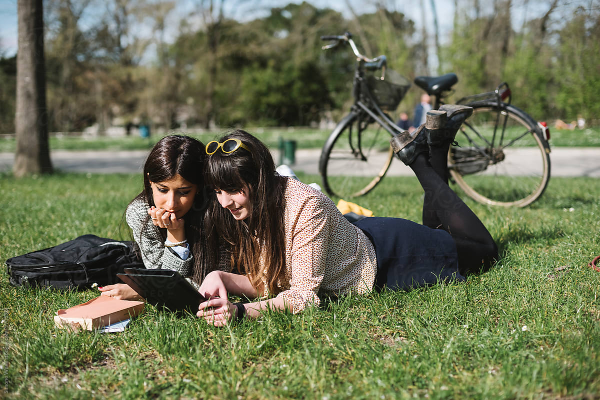 Students using a tablet in the park
