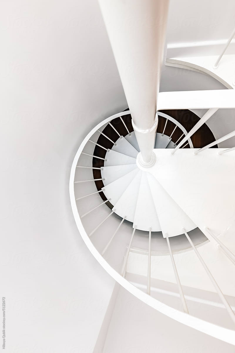 Top view of white spiral staircase. Minimal and clean interior design