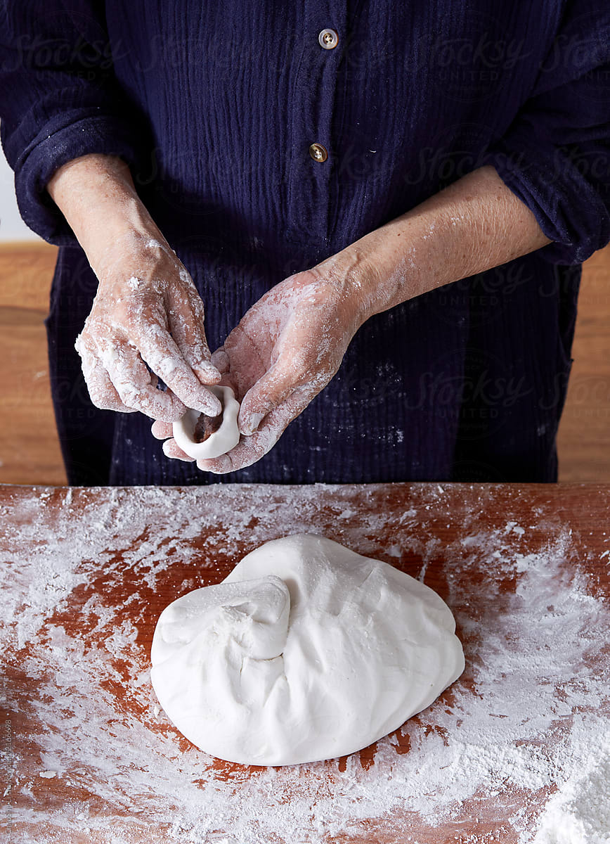 Closeup Asian old woman\'s hand, happy to make Chinese dessert rice dumpling at home.