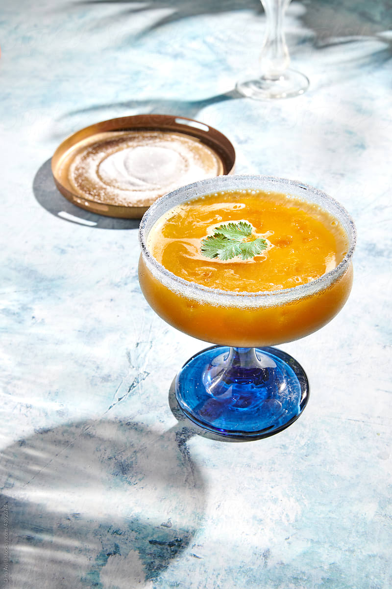 Orange Cocktail in Blue and Clear Coupe Glass