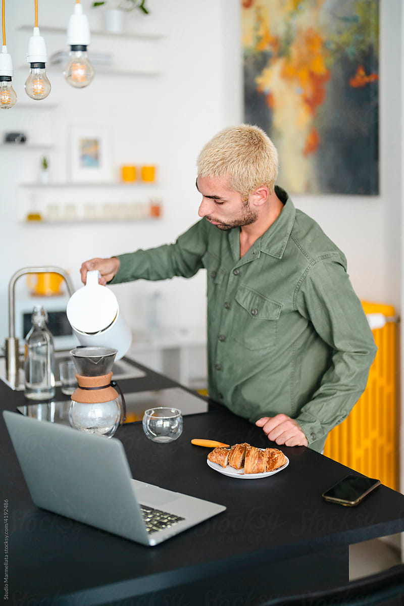 Male brewing coffee in morning