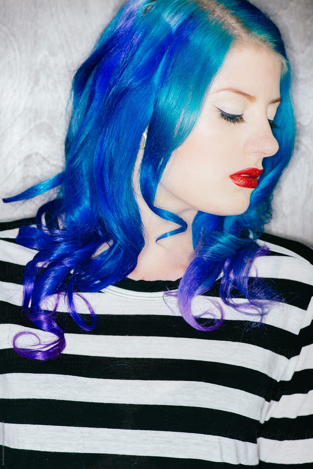 Model with blue hair in harsh light