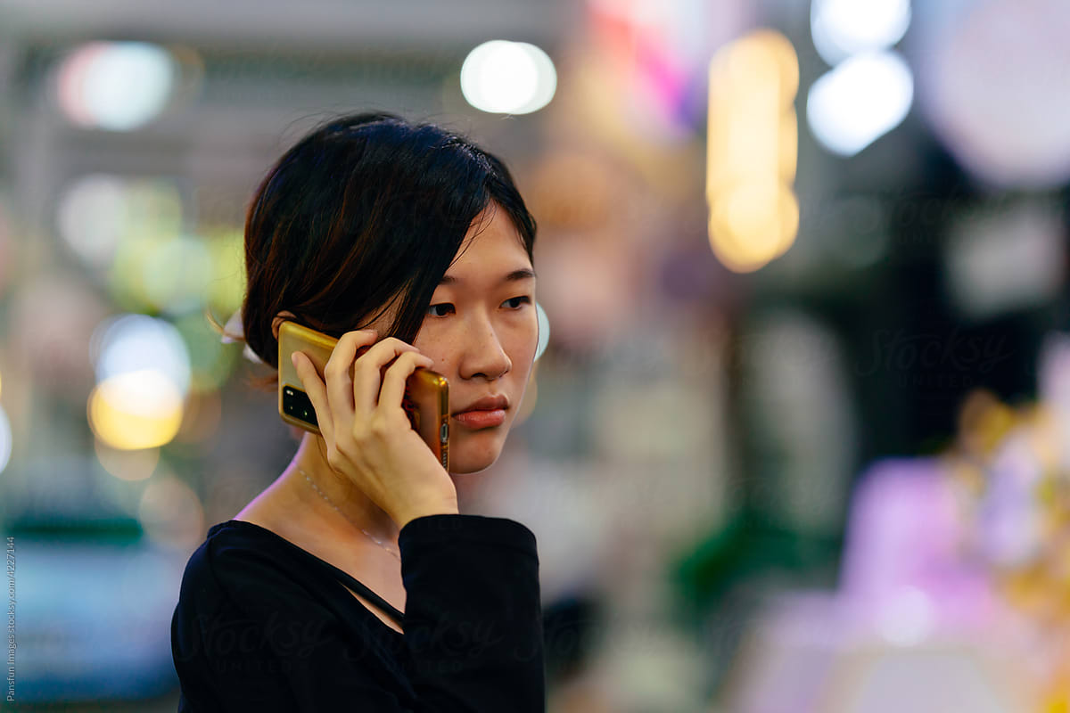 Young female calling with mobile phone