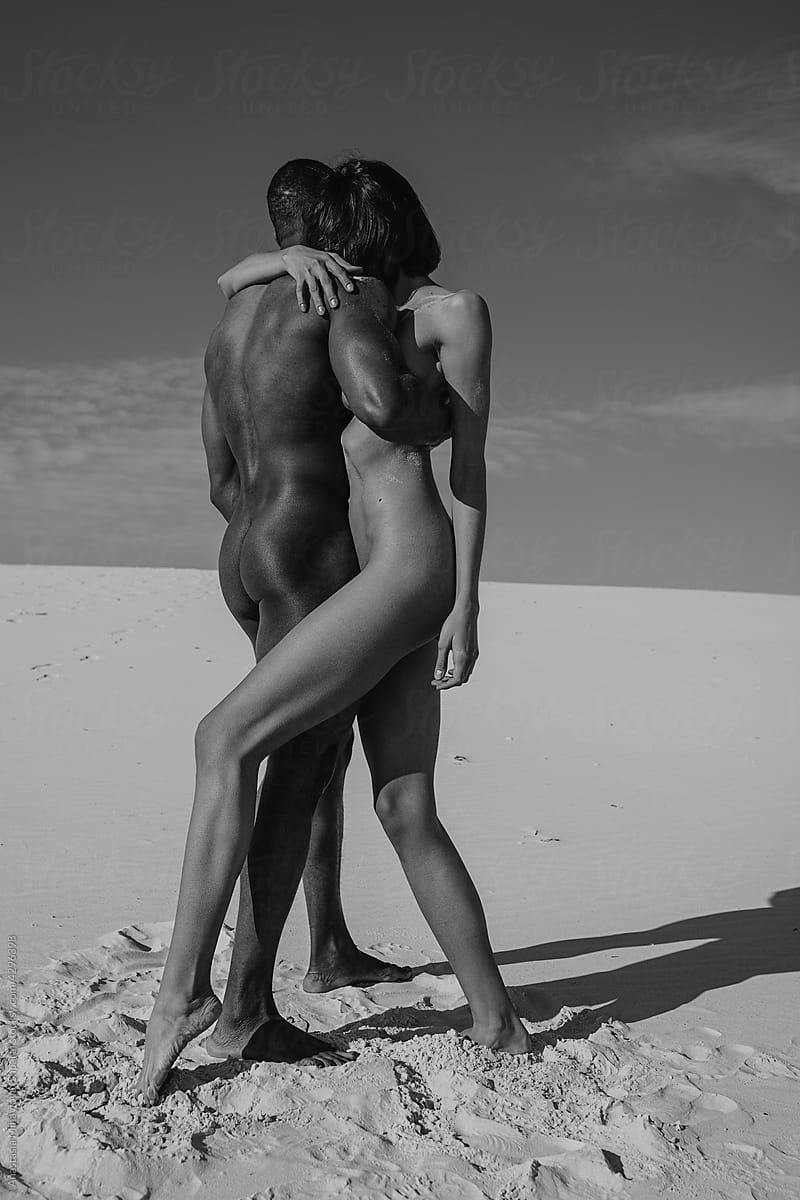 Nude couple in love in the desert monochrome