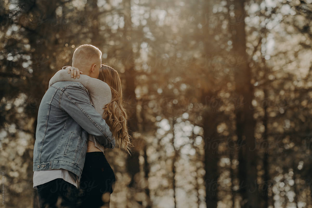 Big tight bear hug in the forest with dreamy sunset light