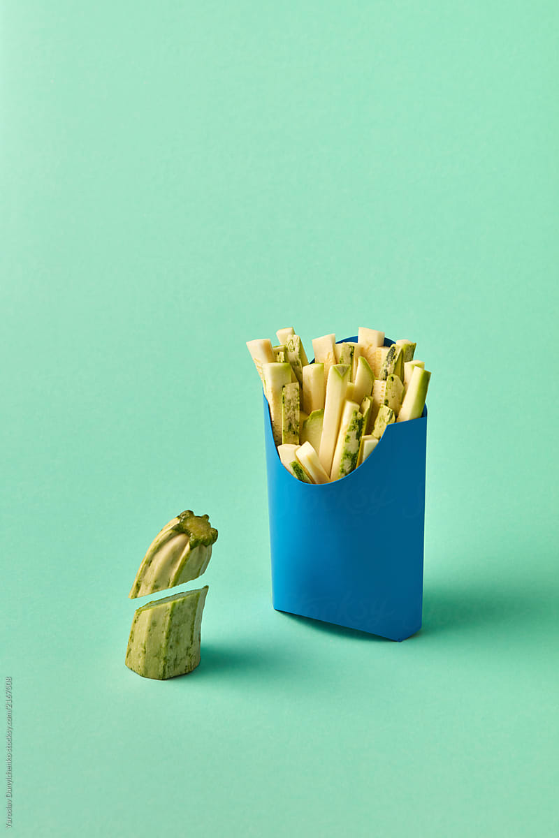 Chopped sticks of zucchini in a paper container - fresh natural