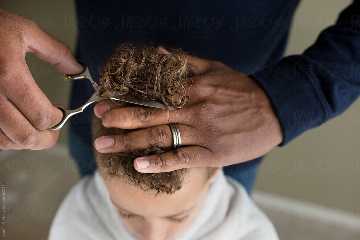 Man with wedding ring cuts son\'s hair