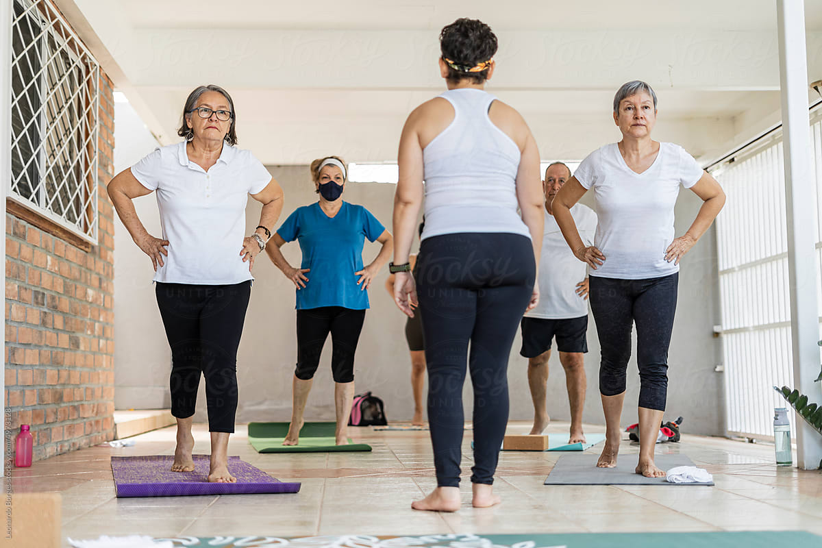 Yoga instructor standing in class with older adults
