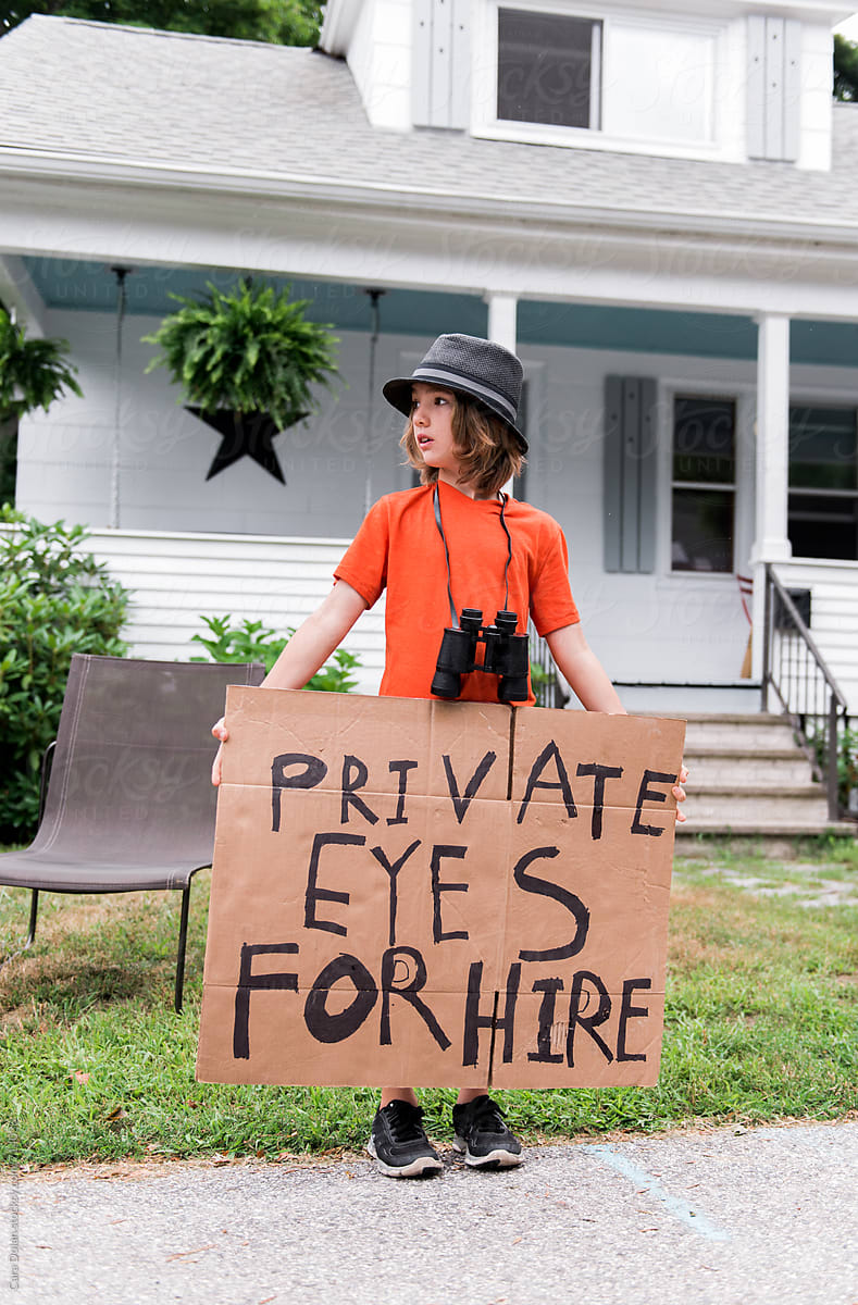 Child holds handmade Private Eyes for Hire sign