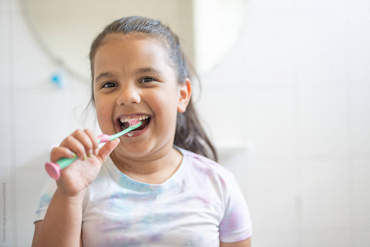 Girl enjoying brushing her teeth