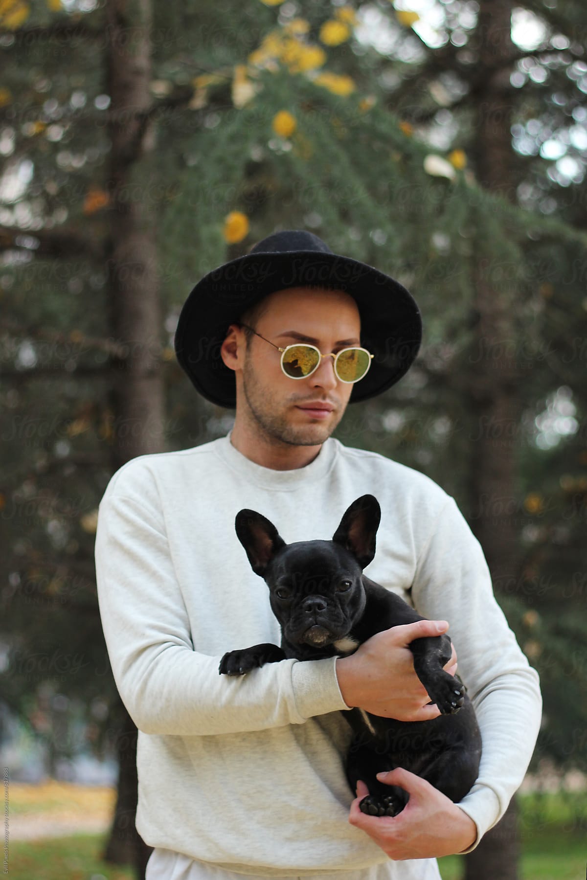 Male model and his little french bulldog