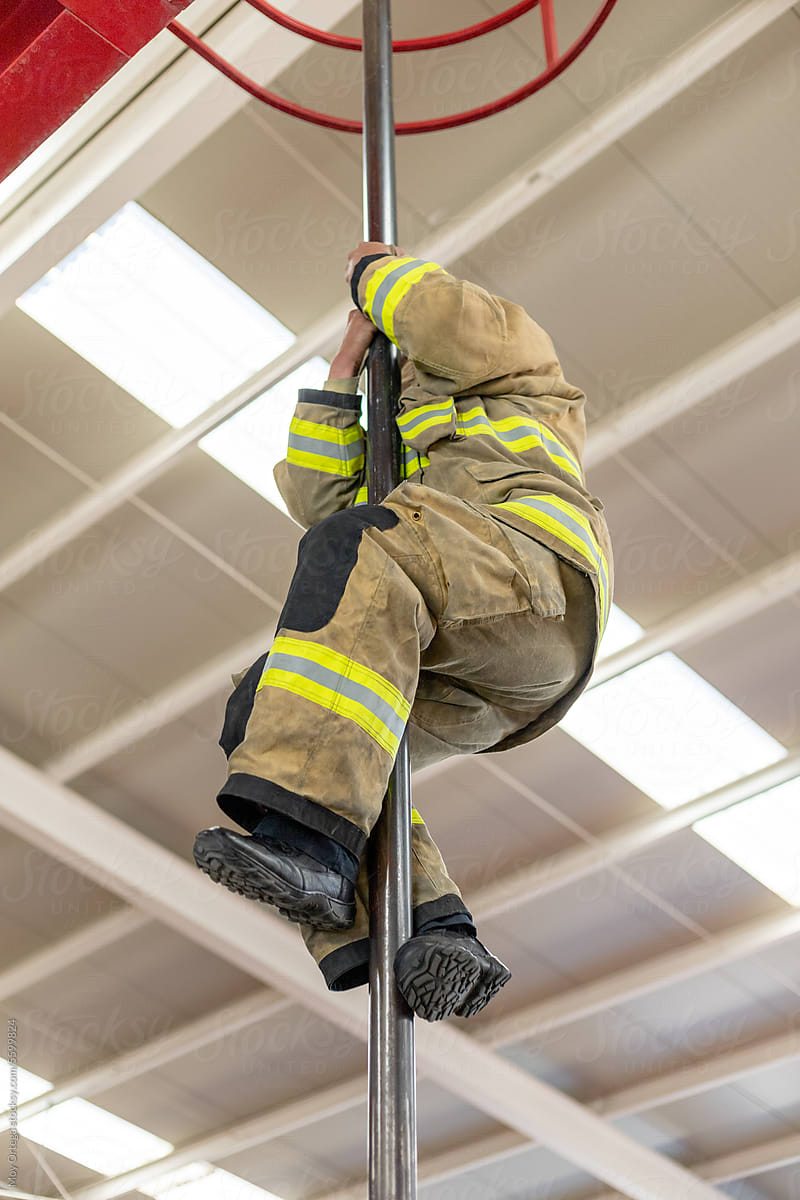 A Firefighter Sliding Down An Emergency Tube