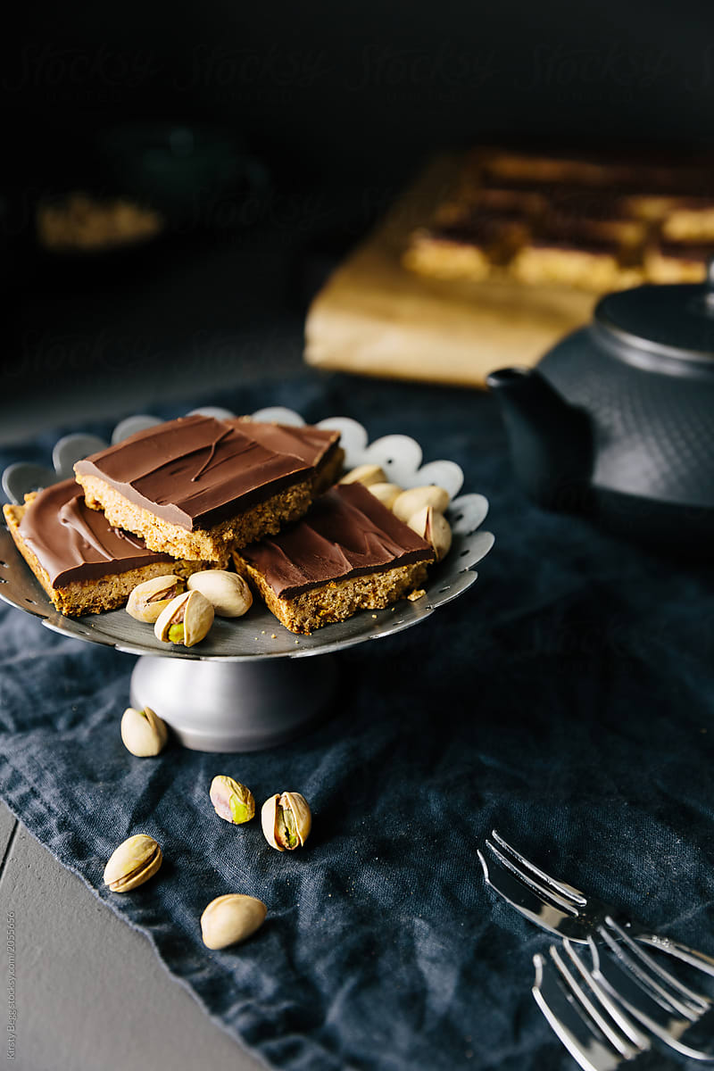 Squares of pistachio shortbread with dark chocolate topping