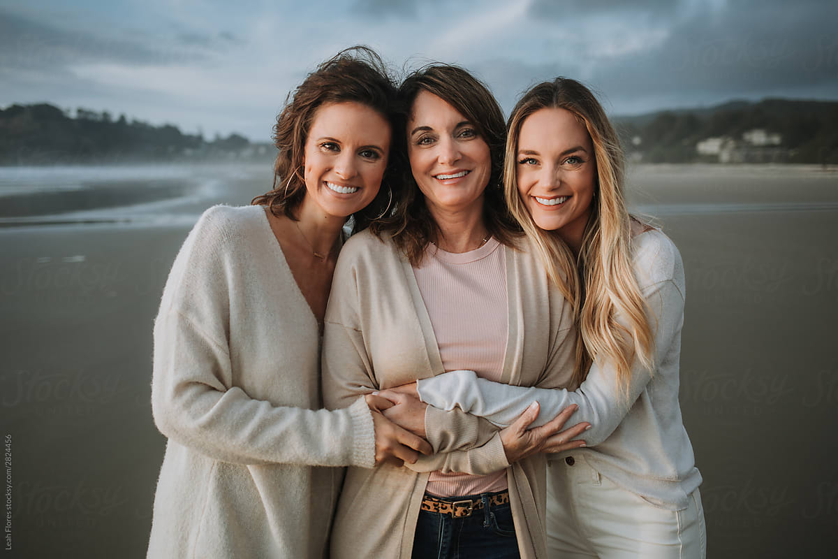 Mother Embracing Her Daughters At The Coast By Stocksy Contributor