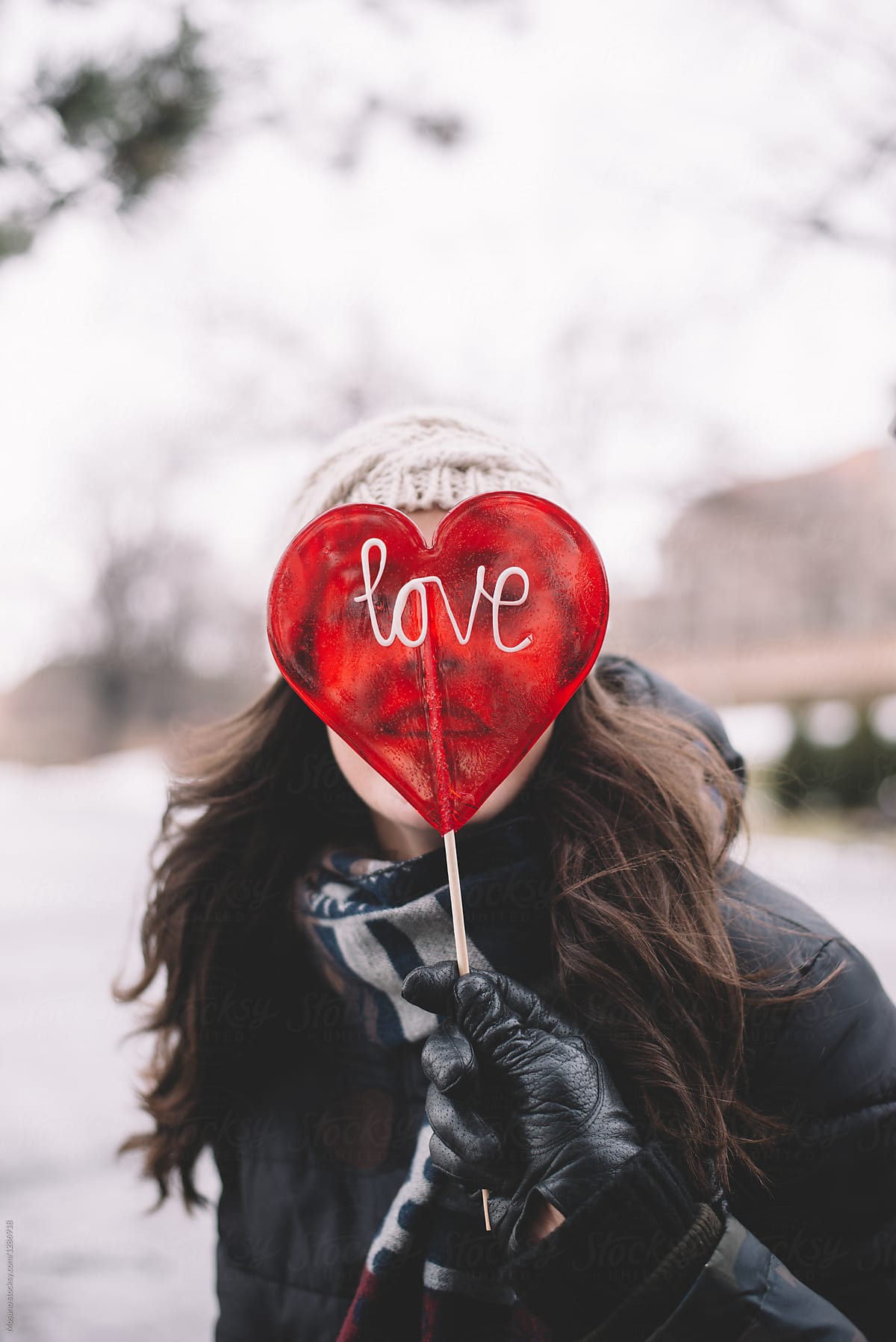 Young Woman Holding Heart Shaped Candy