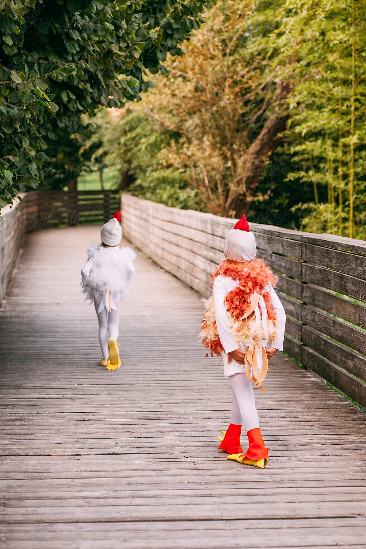 kids walking in a park in a chicken costume