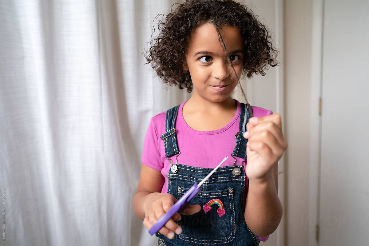 Girl Holding Scissors In Bathroom by Stocksy Contributor Jennifer Bogle  - Stocksy