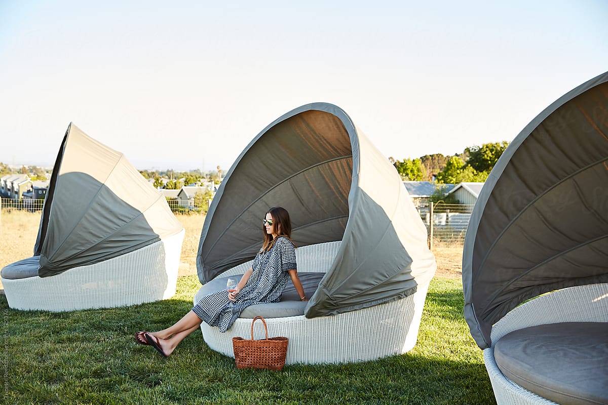 Woman sitting in cabana at luxury resort