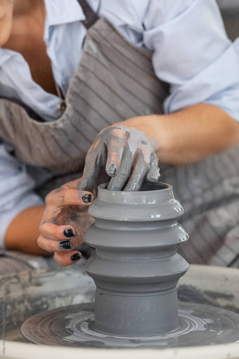 Anonymous woman crafting curvy vase