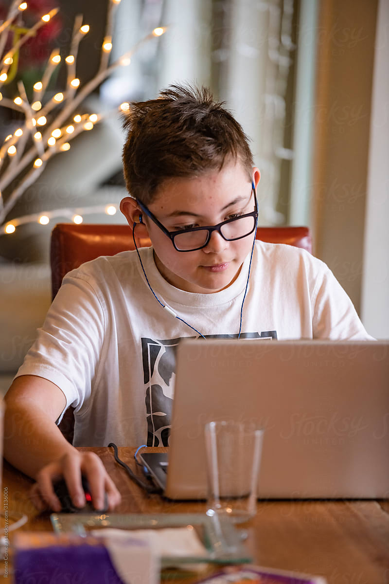Teen Boy Online Gaming on Laptop at Home