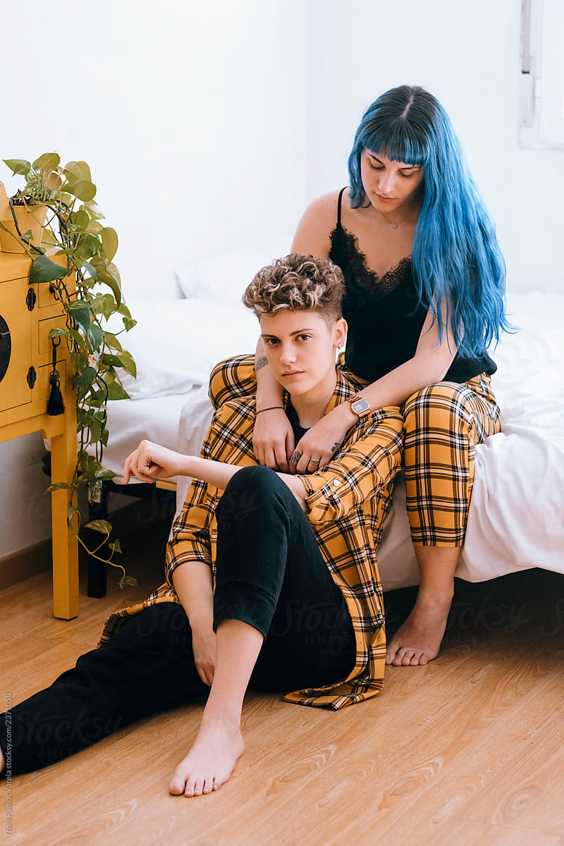 Lesbian Couple Dressed In A Yellow Outfit Are Comfortable In Their Bright White Room By