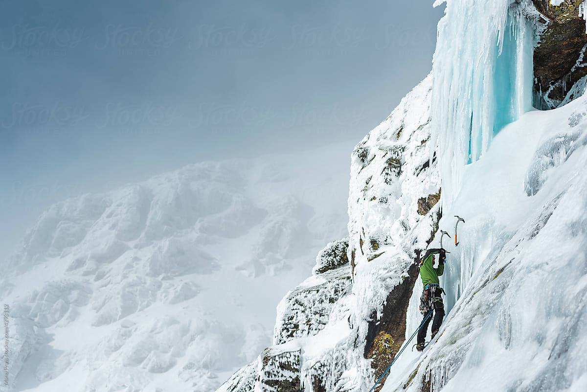 Ice Climbing On Frozen Waterfall