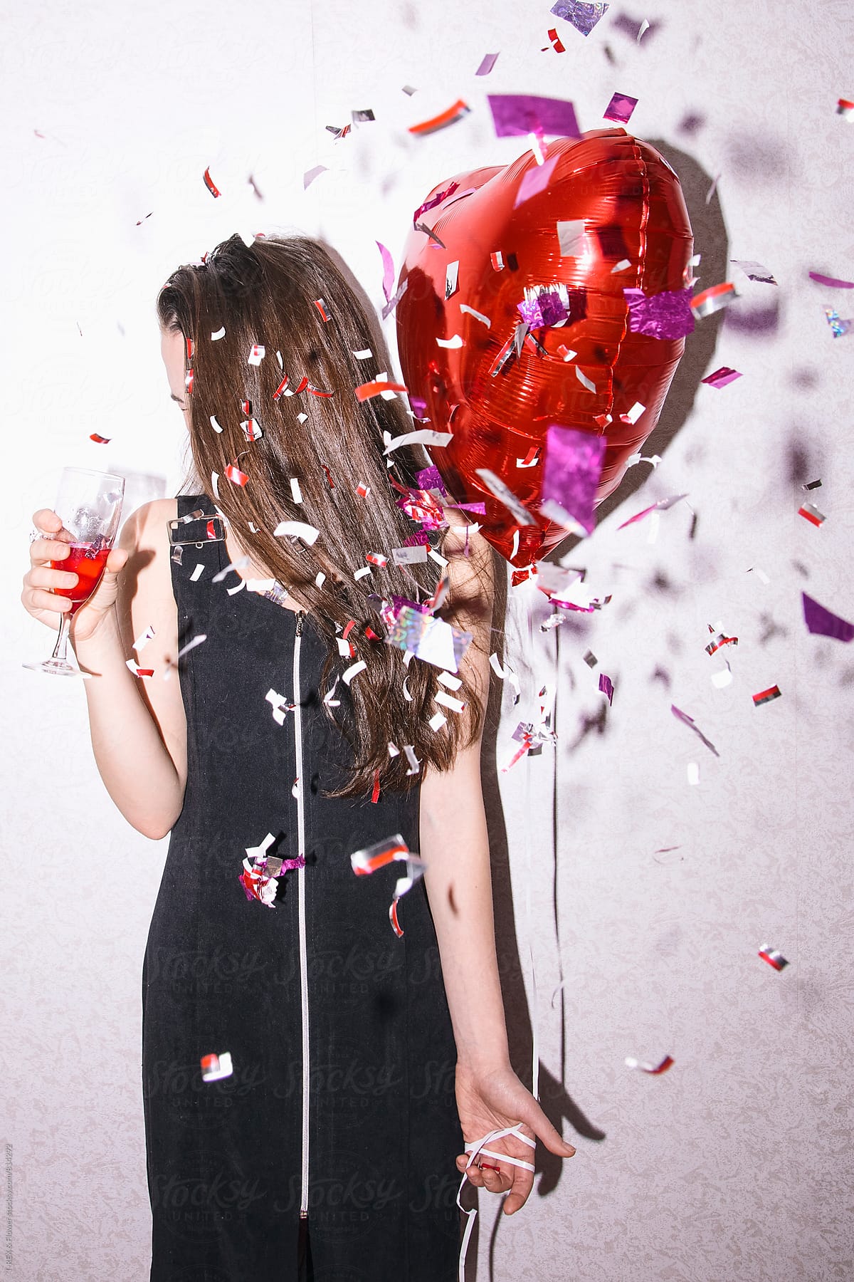 «young Woman In Black Dress Holding Red Balloon And Glass Of Champagne