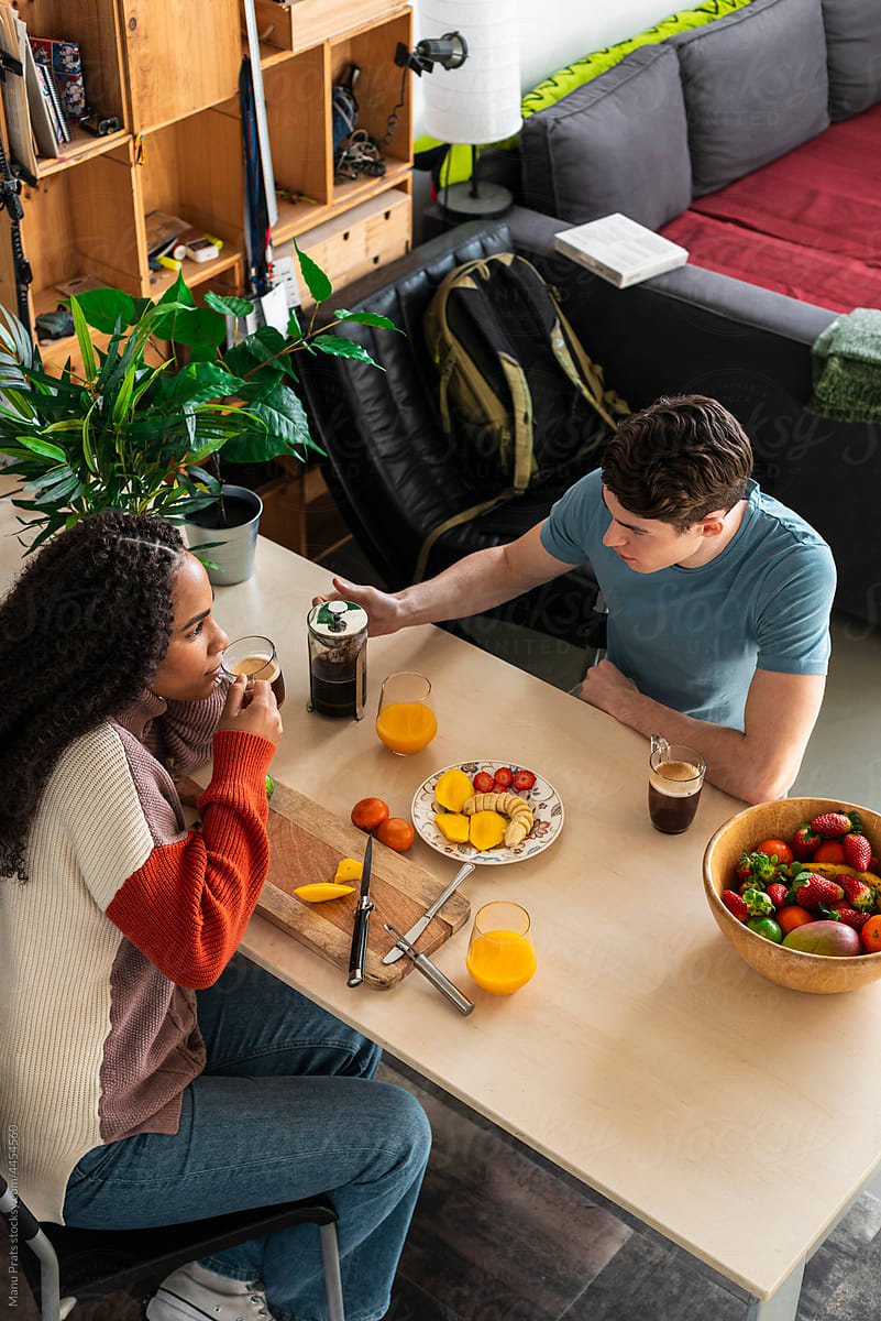 Multiracial Couple Having Breakfast With Vegetarian Food By Stocksy