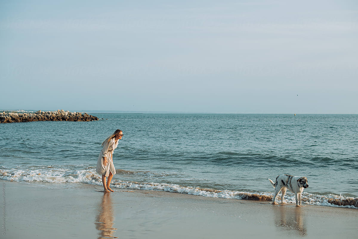 Woman and her dog at the beach