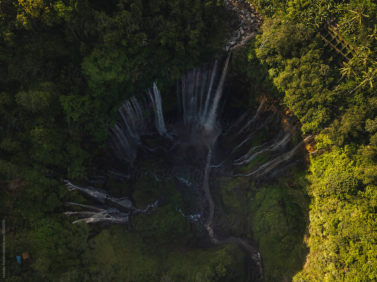 huge waterfall in green lush jungle from above