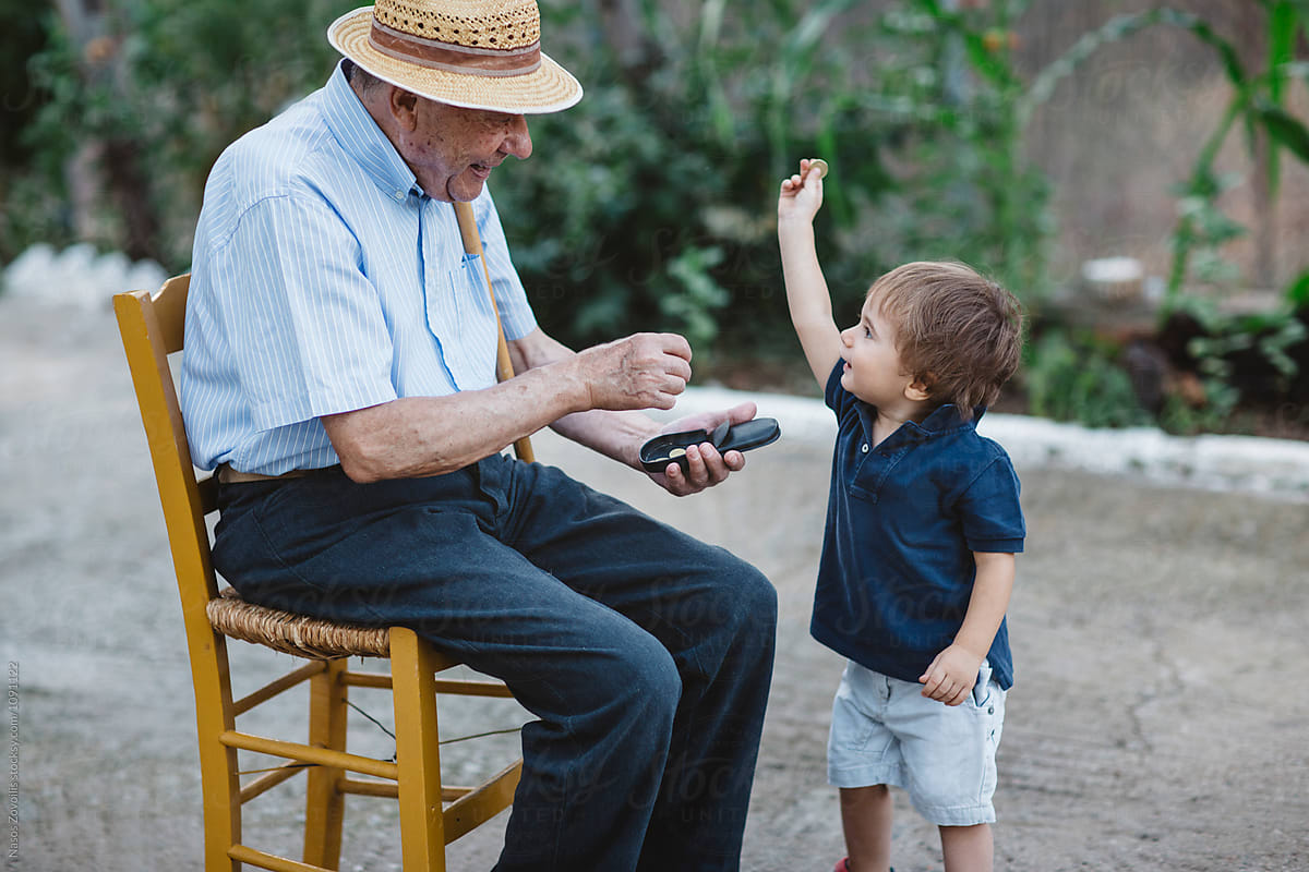 Grandfather giving money to his grandchild
