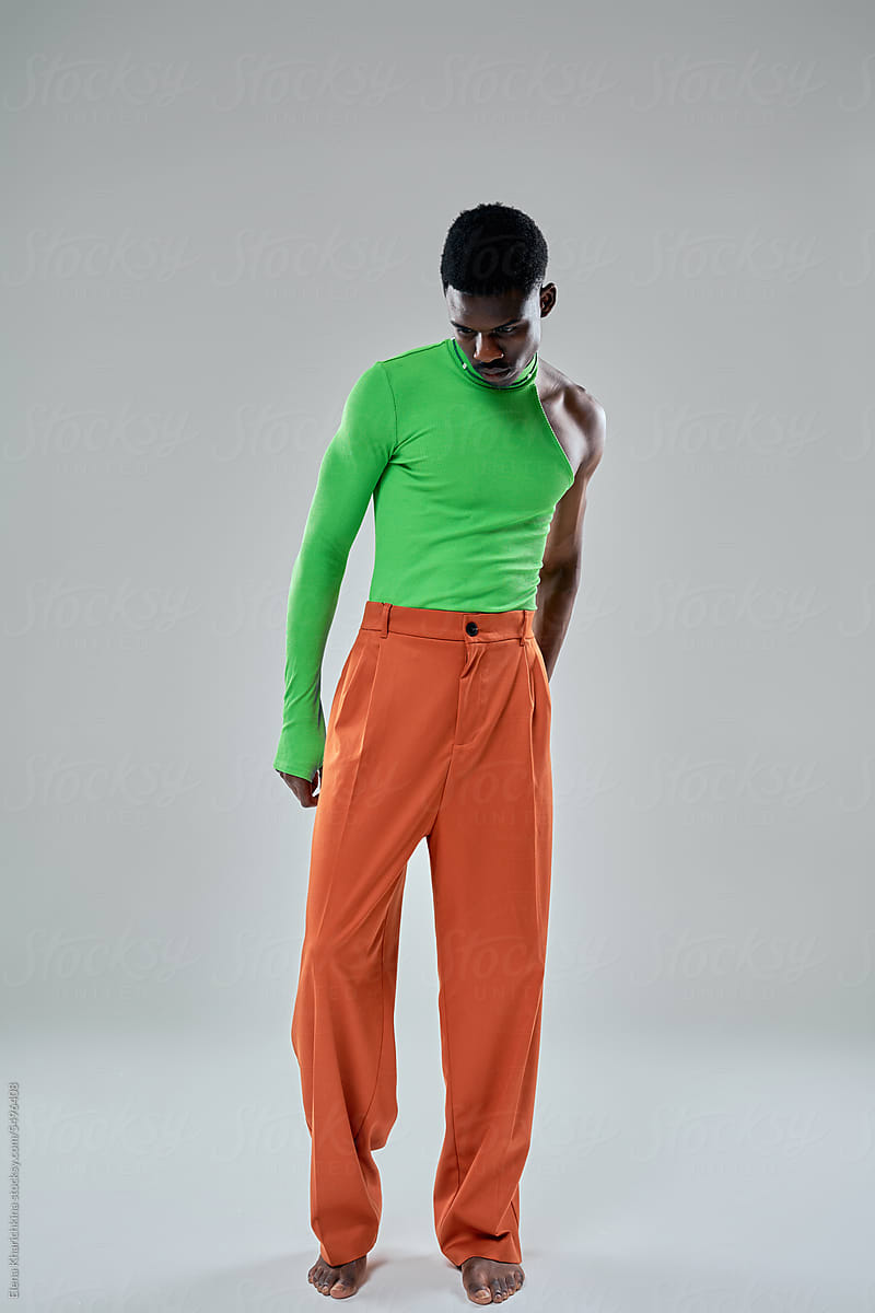 Stylish black woman in trendy outfit in studio