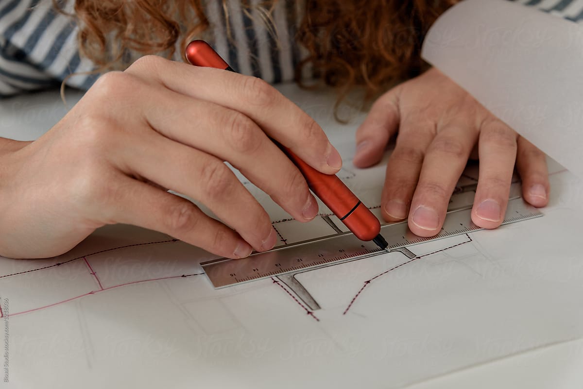 Female drawing line using ruler