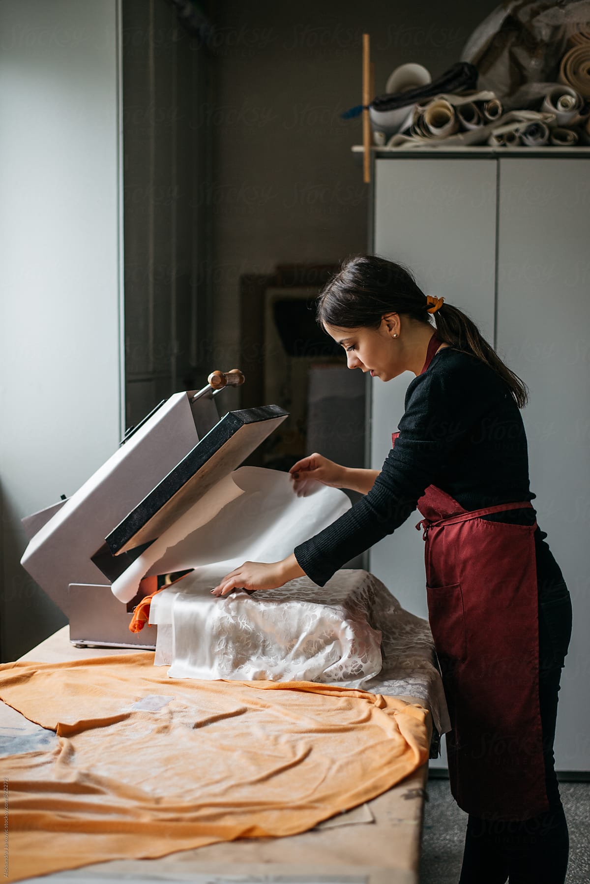Female textile designer working on the heat transfer press