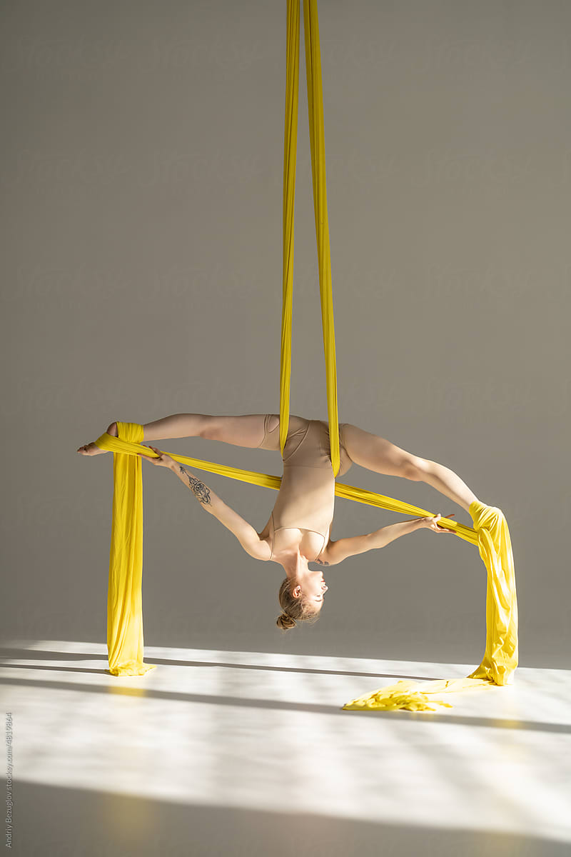 Performance of circus artist with colorful fabric ribbons