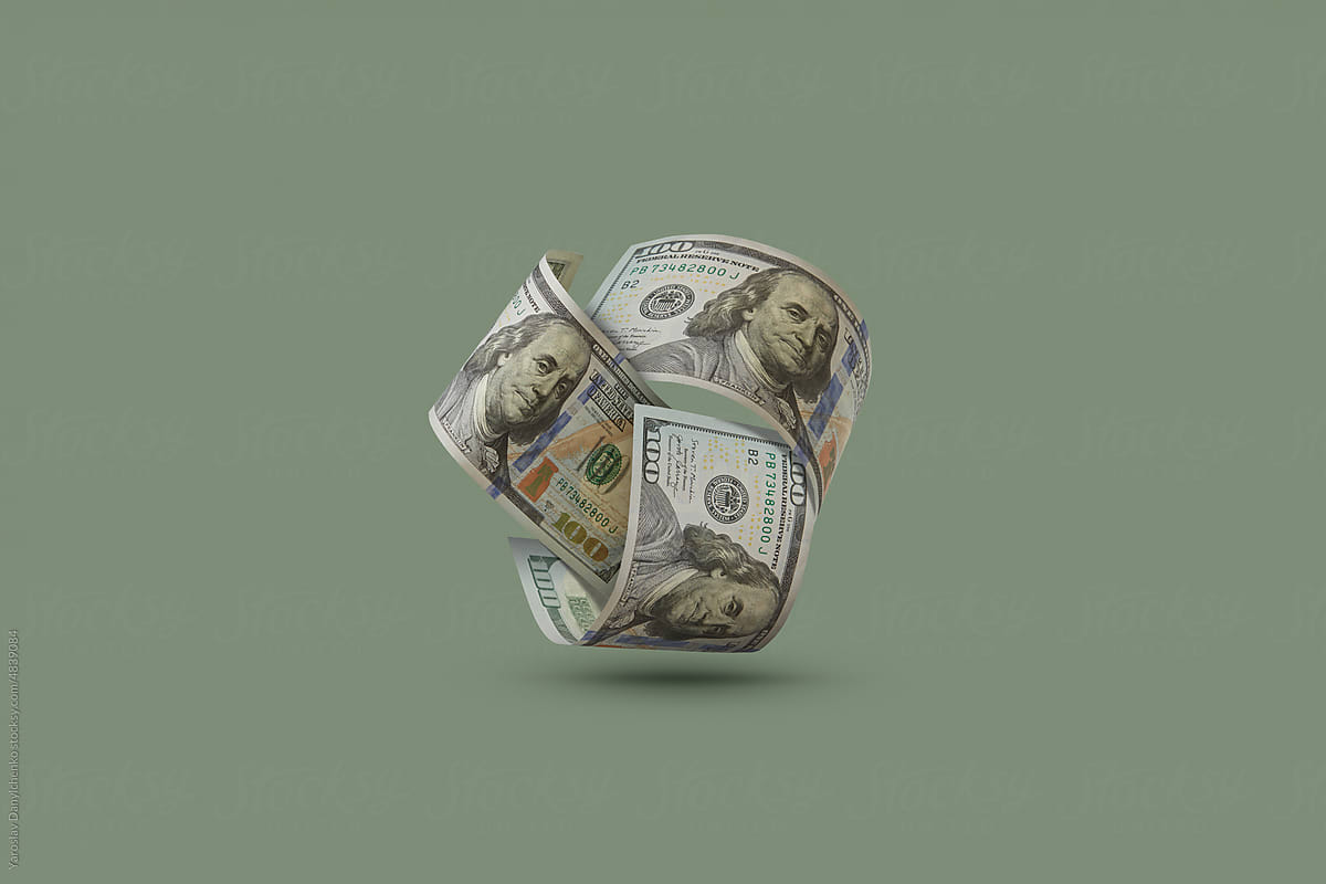 Dollars in form of ball on green background.