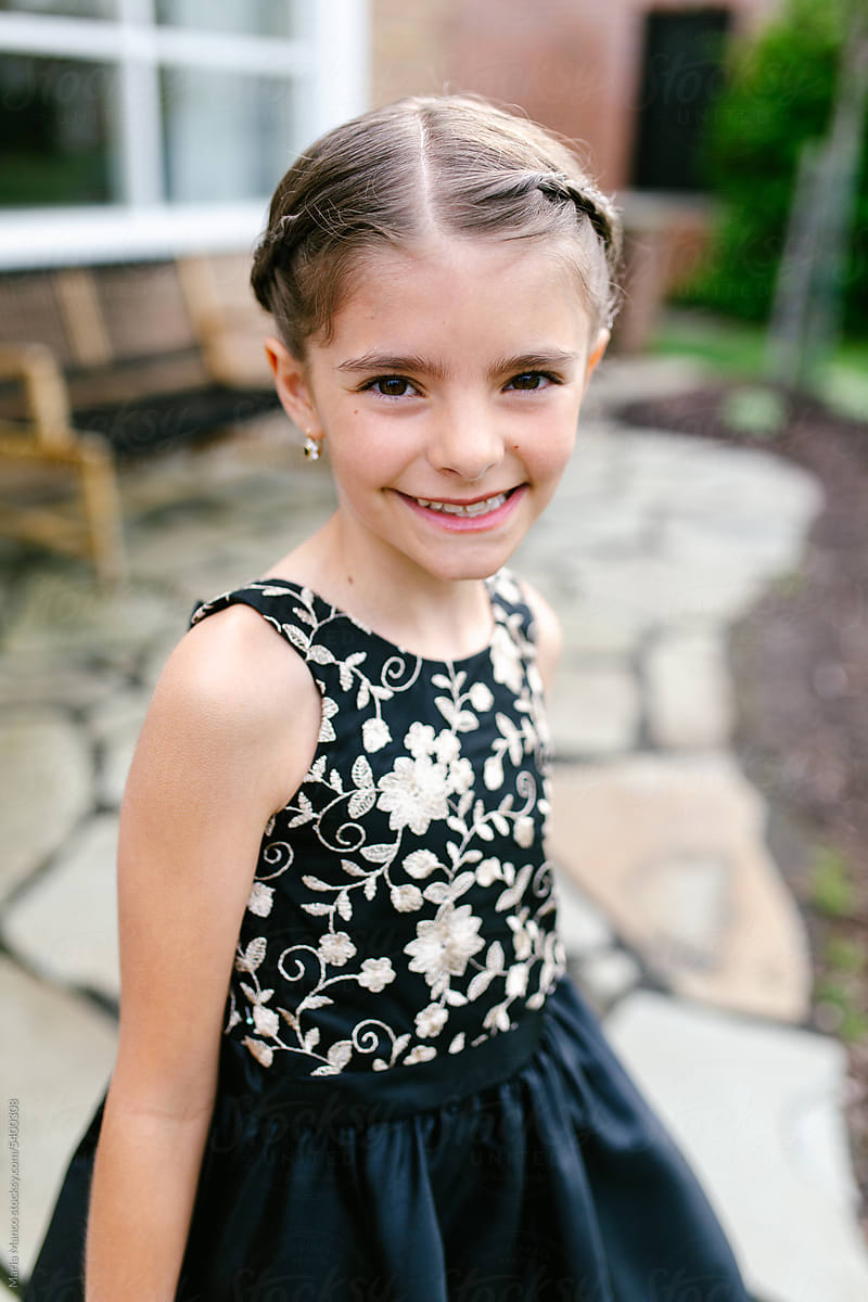 Young tween girl poses for photo in formal dress
