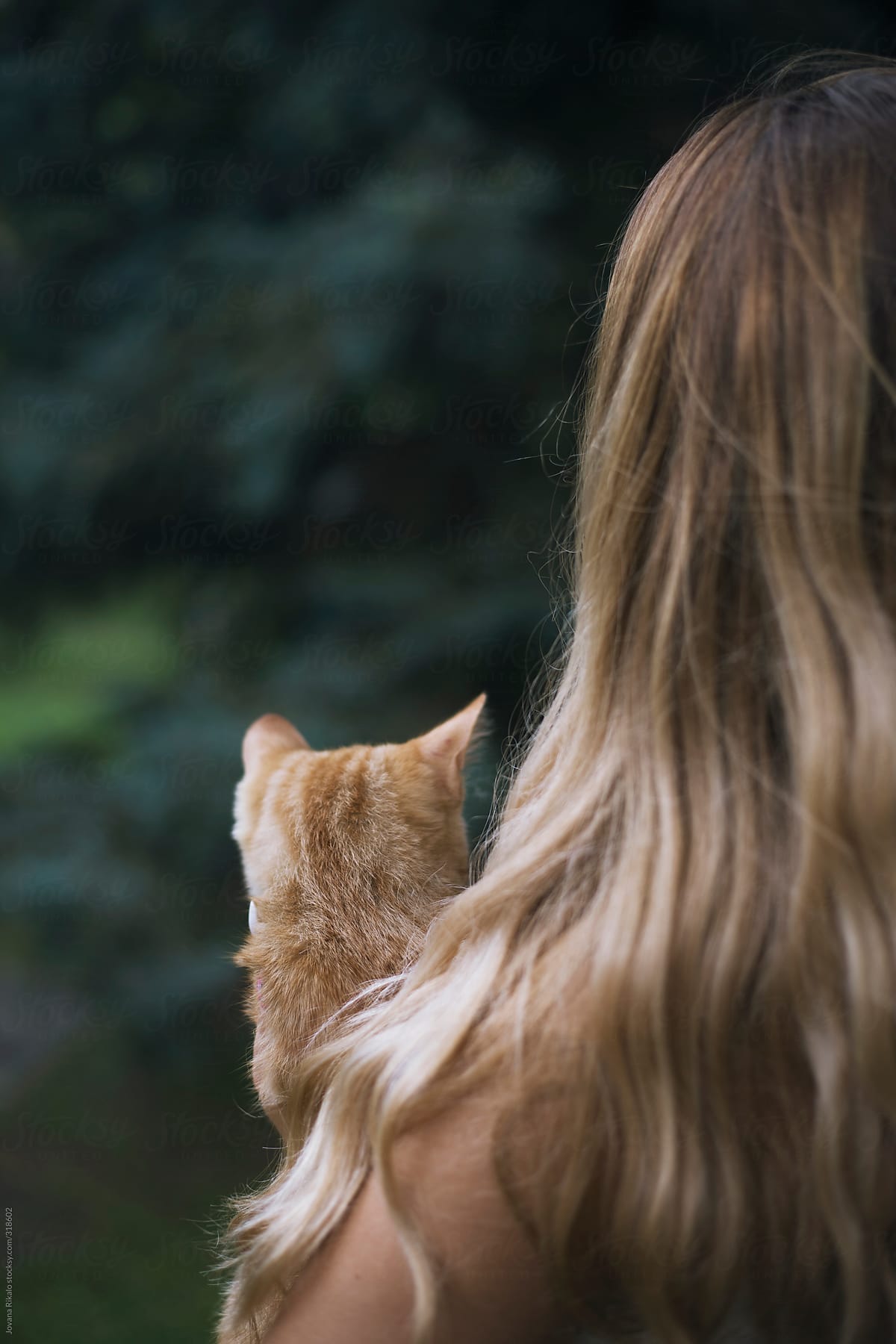 Back view of a young woman and her kitty