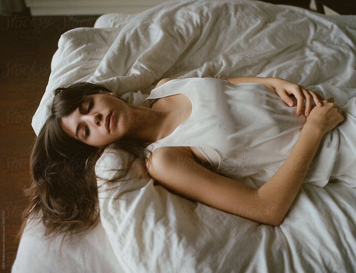 Beautiful Girl Lying In White Bed