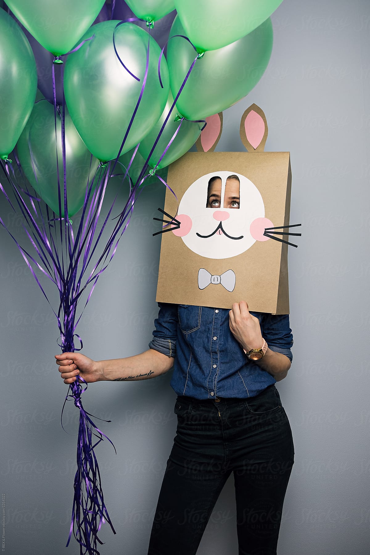 Person with balloons in bunny mask