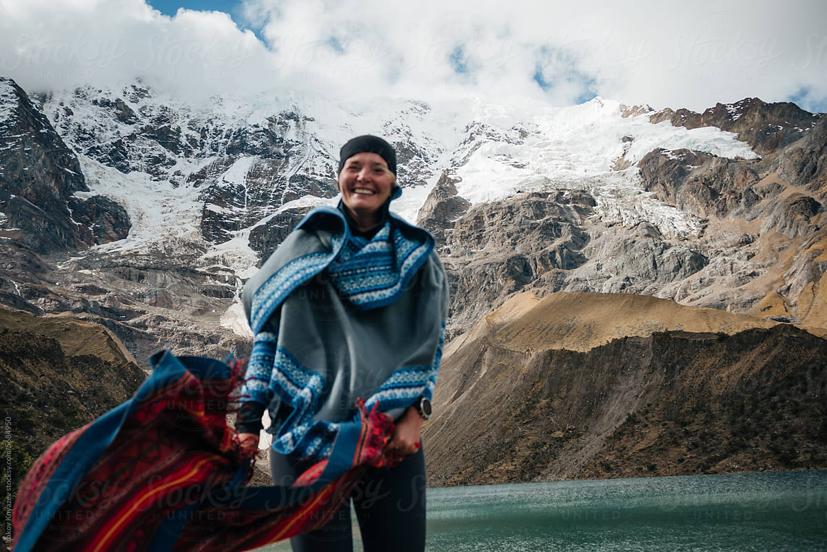 defocused Woman on a high  Mountain wrapped in poncho