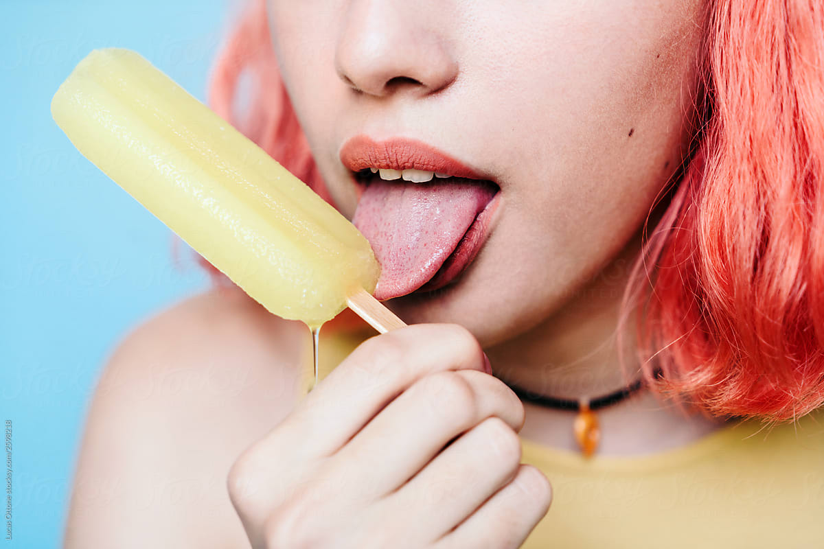 Young woman with lemon ice lolly