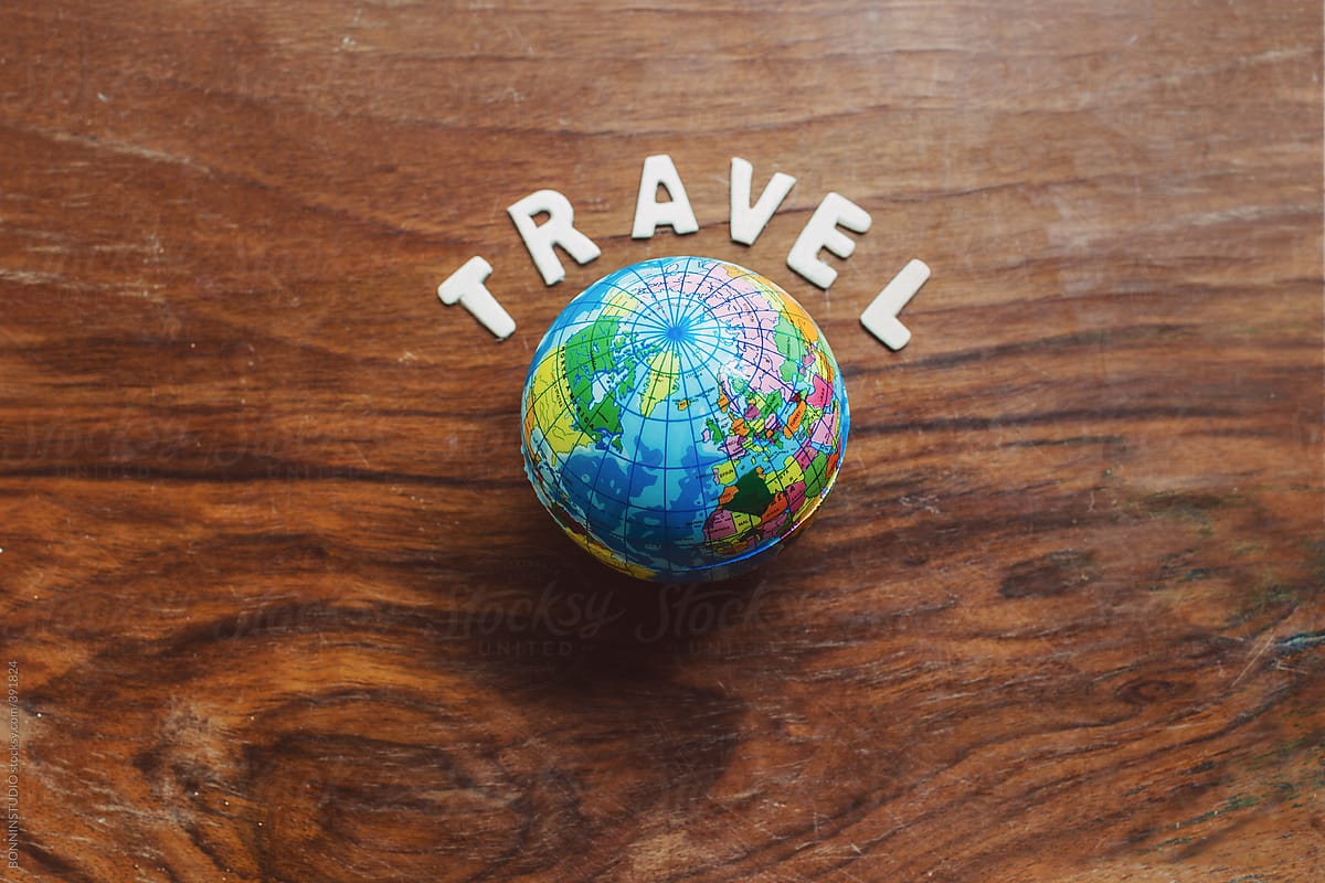 The world. Small globe on wooden background.