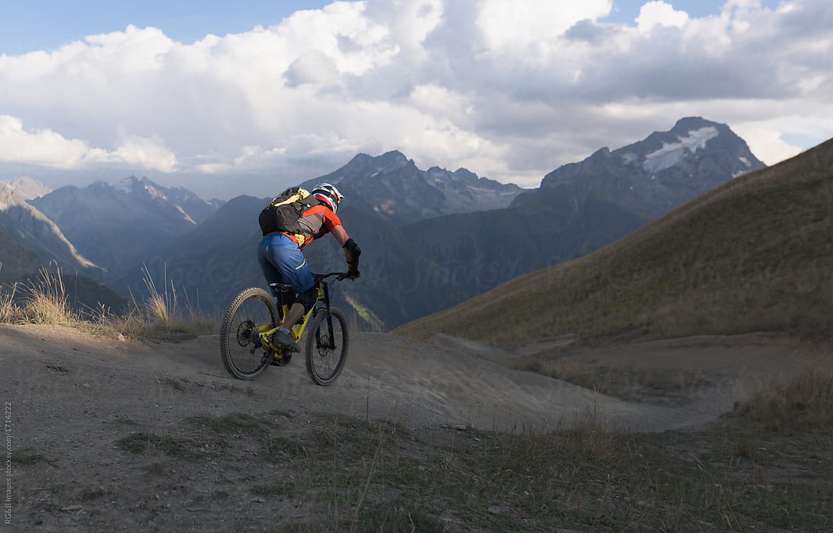 Man riding mountain bike downhill backcountry route