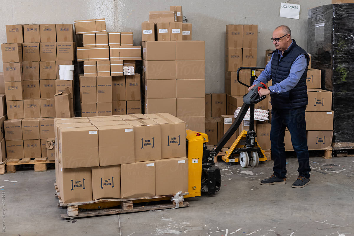 Business warehouse worker with pallet truck