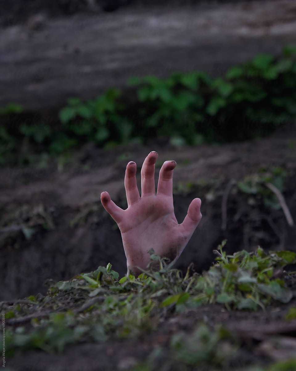 Hand Reaching from Ground in Dirt
