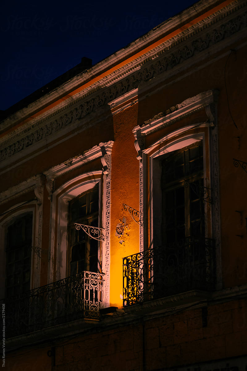 Window with colonial architecture illuminated at night